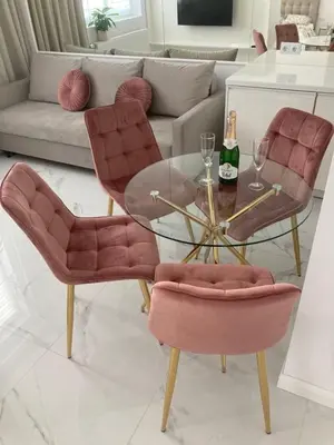 a living room with a glass table and pink chairs at Apartamenty Parkowe B18 in Oświęcim