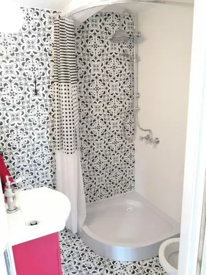 a bathroom with a shower and a toilet and a sink at Red Bed in Jankowice