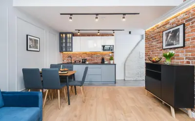 a kitchen and dining room with a brick wall at Saint Florian's Suites - Old Town Luxury Apartments - by Upstairs in Kraków