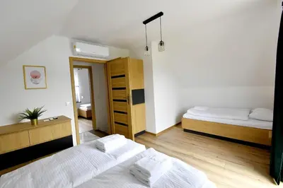 a bedroom with two beds and a closet at Domki na Krótkiej in Spytkowice
