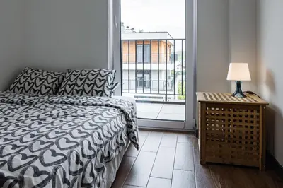 a bedroom with a bed and a large window at ENERGYLANDIA Zator Apartament Krzyś in Zator