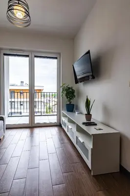 a living room with a tv on a wall at ENERGYLANDIA Zator Apartament Krzyś in Zator