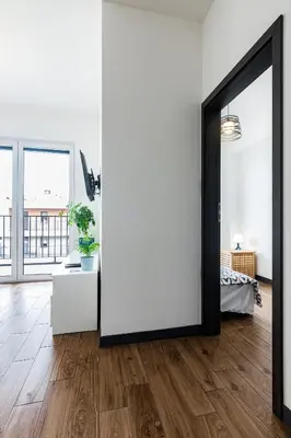 a room with a large mirror and a white wall at ENERGYLANDIA Zator Apartament Krzyś in Zator