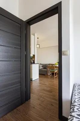 a bedroom with a door leading into a living room at ENERGYLANDIA Zator Apartament Krzyś in Zator