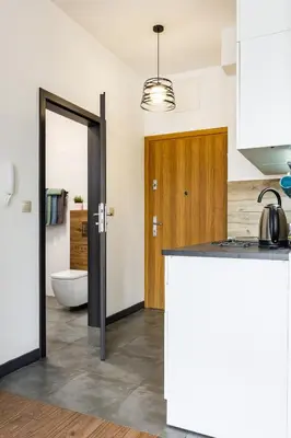a kitchen with a counter top and a bathroom at ENERGYLANDIA Zator Apartament Krzyś in Zator