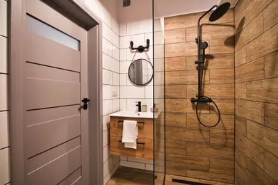a bathroom with a shower and a glass door at LOFT 24 by Housine in Zator