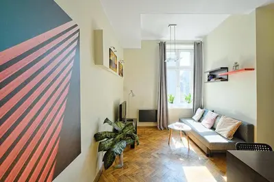 a living room with a couch and a table at Urban Nest Apartments Dietla 69 in Kraków