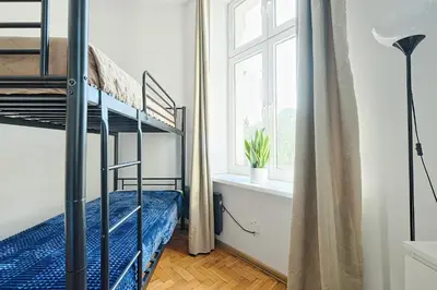 a bedroom with a bunk bed and a window at Urban Nest Apartments Dietla 69 in Kraków