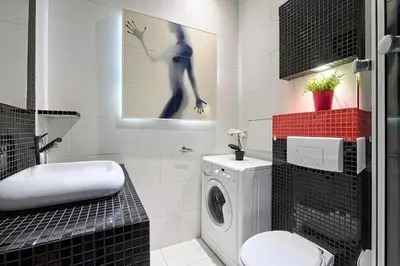 a bathroom with a washing machine and a sink at Urban Nest Apartments Dietla 69 in Kraków