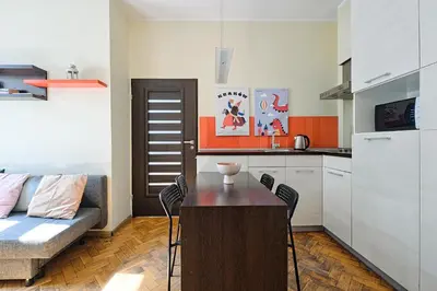 a kitchen with a couch and a table in a room at Urban Nest Apartments Dietla 69 in Kraków