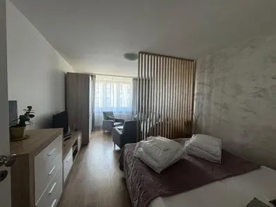 a bedroom with a bed and a desk and a chair at Kalwaryjska Spot Apartment in a Good Location in Kraków
