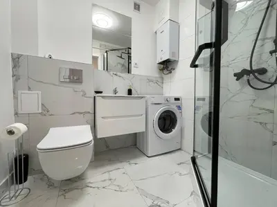 a white bathroom with a washing machine in it at Kalwaryjska Spot Apartment in a Good Location in Kraków