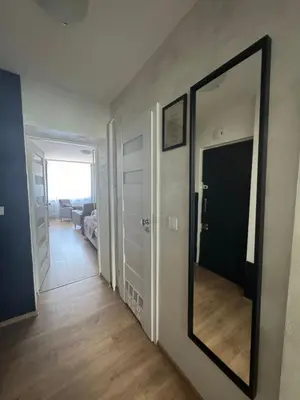 a hallway with a large mirror on a wall at Kalwaryjska Spot Apartment in a Good Location in Kraków