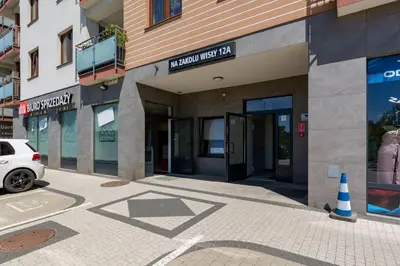 a building with a car parked in front of it at Apartment Na Zakolu Wisły by Noclegi Renters in Kraków