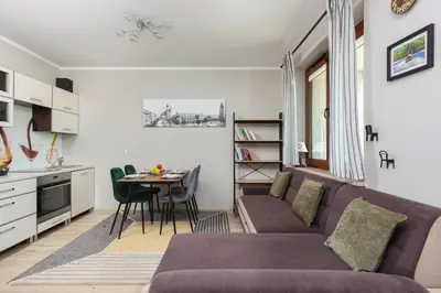 a living room with a couch and a table at Apartment Na Zakolu Wisły by Noclegi Renters in Kraków
