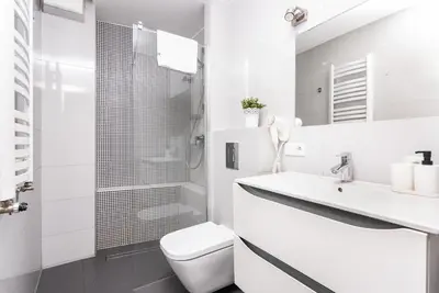 a white bathroom with a toilet and a sink at Blossom - Old Town Residence - by Upstairs in Kraków
