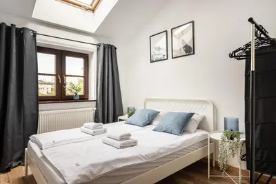 a white bedroom with a bed and a window at Blossom - Old Town Residence - by Upstairs in Kraków