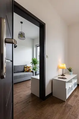 a living room with a couch and a mirror at ENERGYLANDIA Zator Apartament Grześ in Zator