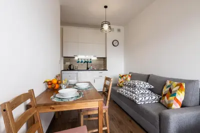 a living room with a couch and a table at ENERGYLANDIA Zator Apartament Grześ in Zator