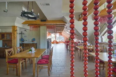 a dining room with a table with red balls on the wall at Villa & Gospoda Krakowska in Kobiernice