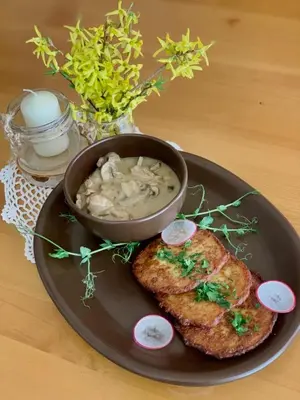 a plate with a piece of fish and a bowl of soup at Villa & Gospoda Krakowska in Kobiernice