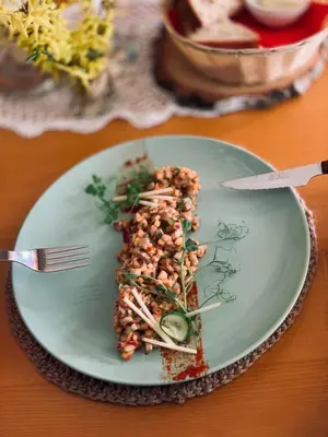 a plate with a piece of food on a table at Villa & Gospoda Krakowska in Kobiernice