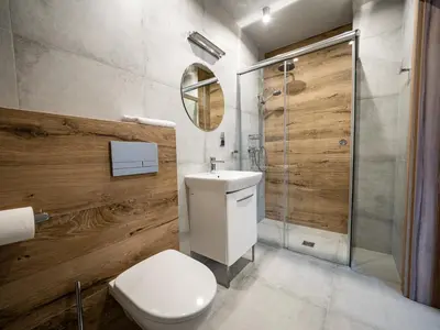 a bathroom with a toilet and a shower and a sink at Villa & Gospoda Krakowska in Kobiernice