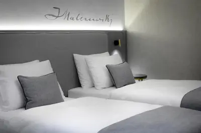 two beds sitting next to each other in a hotel room at Art Boutique in Kraków