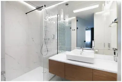 a white bathroom with a sink and a shower at Art Boutique in Kraków