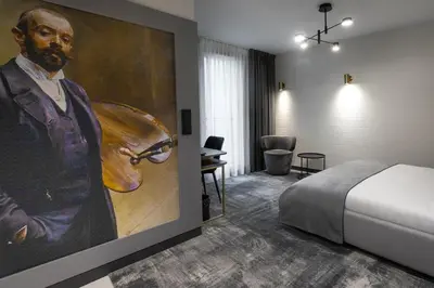 a hotel room with a painting of a man with a guitar at Art Boutique in Kraków