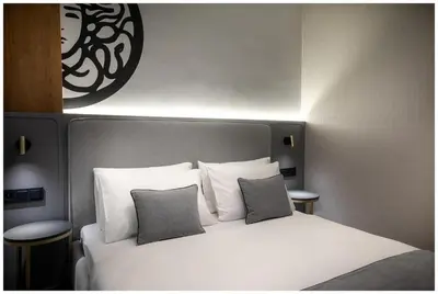 a bedroom with a white bed with two pillows at Art Boutique in Kraków