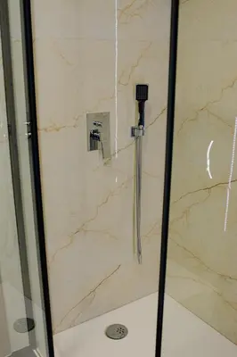 a shower with a glass door in a bathroom at Apartamenty Jordanów - Stacja Paliw MOYA in Jordanów