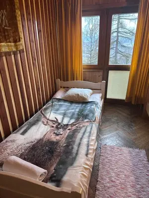 a room with a table and a wreath on a wall at Ayur Garden Peaceful Forest Retreat in Lanckorona in Lanckorona