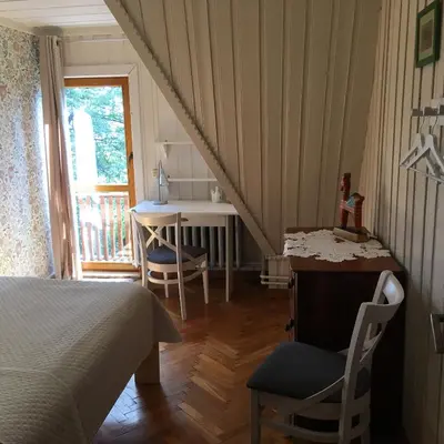 a bedroom with two beds and a window and a radiator at Ayur Garden Peaceful Forest Retreat in Lanckorona in Lanckorona