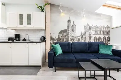 a living room with a blue couch in a kitchen at Ariańska apartment - Cracow, city centre in Kraków