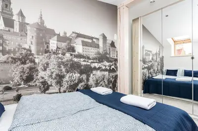 a bedroom with a wall mural of a city at Ariańska apartment - Cracow, city centre in Kraków
