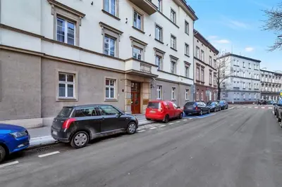 a row of cars parked next to a building at Ariańska apartment - Cracow, city centre in Kraków