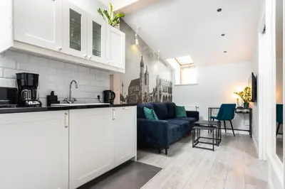 a kitchen and a living room with a couch at Ariańska apartment - Cracow, city centre in Kraków