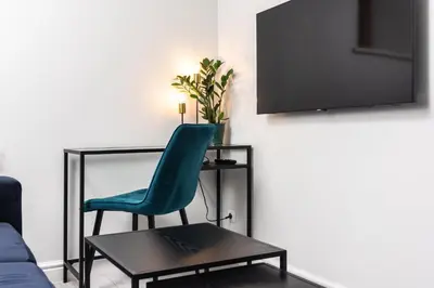 a living room with a green chair and a table at Ariańska apartment - Cracow, city centre in Kraków