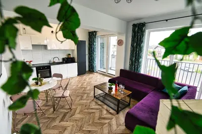 a living room with a purple couch and a table at Kalimera 18 by Housine in Zator