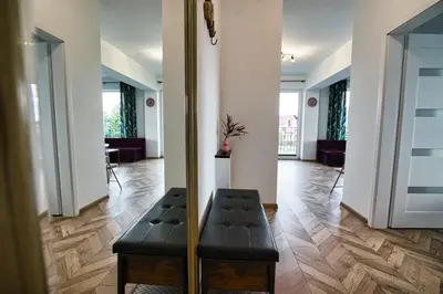 a bedroom with a bed with white sheets and gold pillows at Kalimera 18 by Housine in Zator