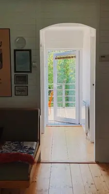a room with an open door to a patio at Domek Mały Las in Rzyki