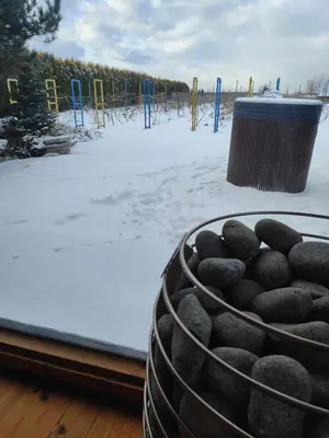 a house with a trash can in the snow at Domki Na Winnicy Zator Przeciszów in Przeciszów