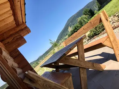 a wooden bench sitting on top of a building at Chatka_Kasina in Kasina Wielka