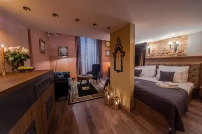 a living room with a couch and two chairs and a table at Ars Cracovia Apartments in Kraków