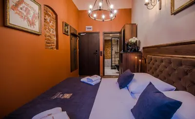 a living room with a couch and a table at Ars Cracovia Apartments in Kraków