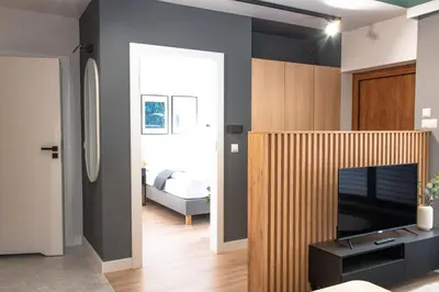 a living room with a television and a room with a bedroom at Riviera Camp in Radłów