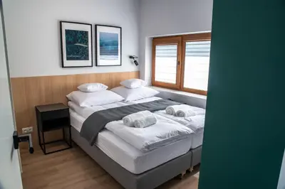 a bedroom with a bed with two pillows and a window at Riviera Camp in Radłów