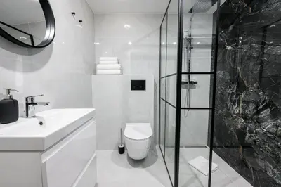 a bathroom with a toilet and a sink and a shower at Native Apartments Paulińska 20 Deluxe in Kraków