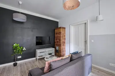 a living room with a couch and a tv at Urban Nest Apartments Blich 8 in Kraków